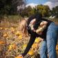 Julia Miller checking out a pumpkin at the Afton Apple Orchard