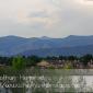 The Hogbacks behind houses on a lake at the Colorado Irish Festival