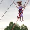 A kid having fun on the bungee jump at the Colorado Irish Festival