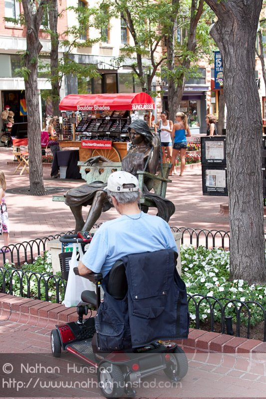 A man sketches "Hearts on a Swing" on the Pearl Street Mall in Boulder, CO