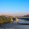 Downtown Minneapolis and the University of Minnesota campus during rush hour from the Franklin Avenue Bridge. The Interstate 94 bridge across the river can be seen.