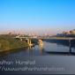Downtown Minneapolis and the University of Minnesota campus during rush hour from the Franklin Avenue Bridge. The Interstate 94 bridge across the river can be seen.
