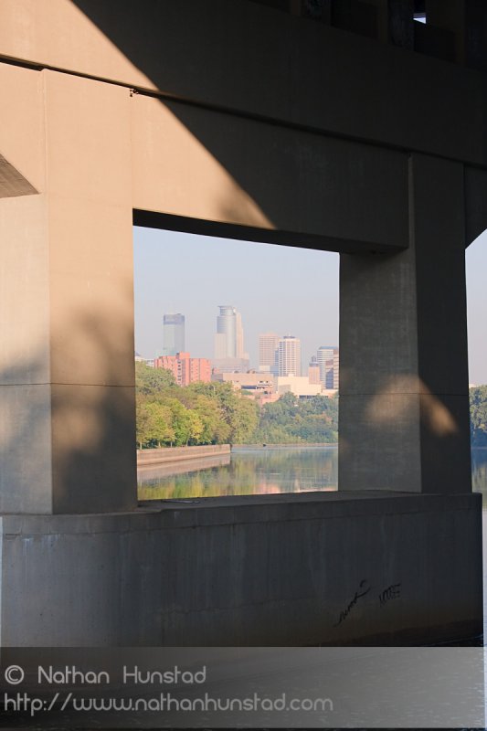 A bridge pier for the Dartmouth Bridge frames downtown Minneapolis.