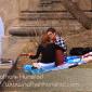 Two people play guitar and listen to the old vinyl near Lake of the Isles.
