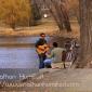 Two guitar players around Lake of the Isles.