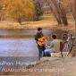 Two guitar players around Lake of the Isles.
