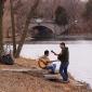 Two guitar players around Lake of the Isles.