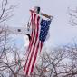 A flag hangs from a cherry picker