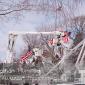 Several flags hang from cherry pickers