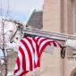 A flag hangs from a cherry picker in front of the House of Hope Presbyterian Church on Summit Avenue